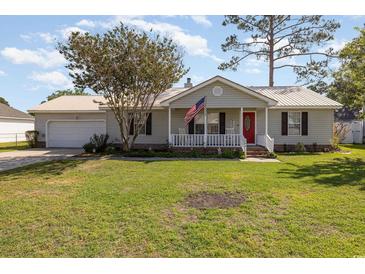 Charming single-story home with well-maintained lawn, front porch, and attached garage at 706 Chippendale Dr., Myrtle Beach, SC 29588