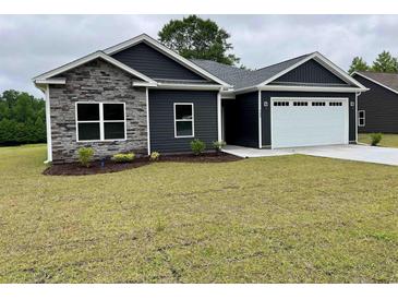 Charming single-story home featuring stone accents and a two-car garage at 722 Highway 348, Loris, SC 29569