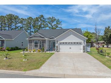 Charming home featuring stone accents, manicured lawn, and an attached two-car garage at 804 Twickenham Loop, Longs, SC 29568