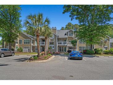 Inviting condo with two-story facade, complemented by well-manicured landscaping and ample parking at 900 Courtyard Dr. # K7, Myrtle Beach, SC 29577