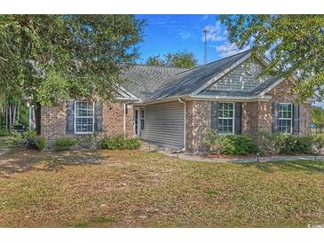 Charming brick home with well-maintained landscaping and inviting curb appeal, showcasing its classic design elements at 101 Alpharetta Ct., Conway, SC 29526