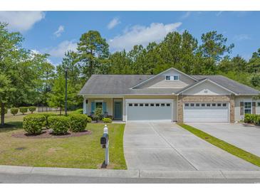 Charming single-story home featuring a two-car garage, well-manicured lawn, and lovely landscaping at 101 Fulbourn Pl., Myrtle Beach, SC 29579