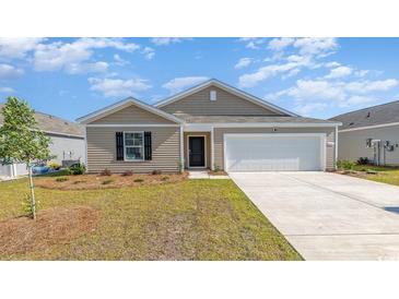 Charming single-story home with a well-manicured lawn and a two-car garage at 1406 Nokota Dr., Conway, SC 29526