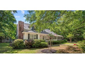 Charming home featuring mature trees, well-maintained landscaping, and inviting front porch at 3772 Brown Bark Ln., Murrells Inlet, SC 29576