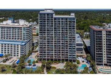 A high-rise condo building featuring pools, palm trees, and other beachside amenities at 5308 N Ocean Blvd. # 504, Myrtle Beach, SC 29577
