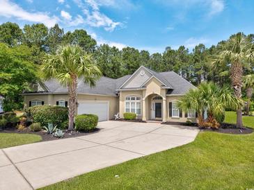 Charming single-Gathering home showcasing mature landscaping and a long driveway and attached garage at 5916 Falcon Landing Circle, North Myrtle Beach, SC 29582