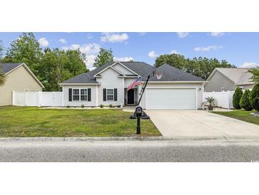 Charming single-story home featuring a well-manicured lawn, attached two car garage, and inviting curb appeal at 649 W Perry Rd., Myrtle Beach, SC 29579
