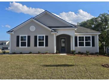 Charming single-story home with light gray siding, black shutters, and a well-maintained lawn on a sunny day at 725 Choctaw Dr., Conway, SC 29526