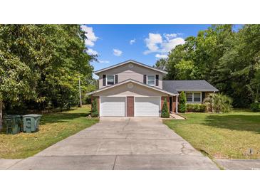 Charming two-story home with a well-maintained lawn and a two-car garage at 1720 Horry St., Conway, SC 29526