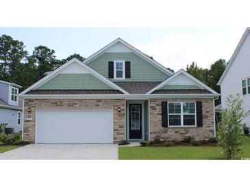Beautiful exterior of a home featuring stone accents, a two-car garage, and manicured landscaping at 333 Glacier Way, Conway, SC 29526