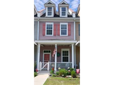 Charming two-story townhouse with a inviting front porch and colorful details at 3358 Pampas Dr., Myrtle Beach, SC 29577