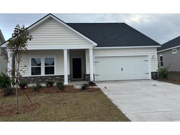 Charming single-Gathering home featuring a two-car garage, landscaped yard, and inviting front porch at 534 Magnolia Terrace Dr, Myrtle Beach, SC 29579