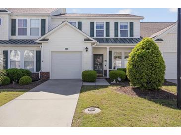 Charming two-story home with a well-manicured lawn, attached garage, and complementary landscaping at 6095 Catalina Dr. # 1613, North Myrtle Beach, SC 29582