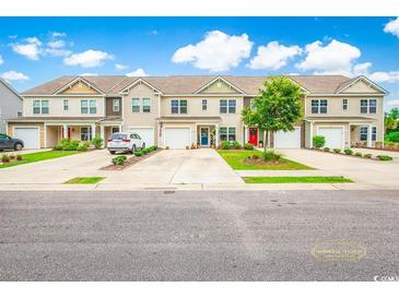 Charming townhomes with individual garages, driveways, and manicured landscaping enhance curb appeal at 1147 Fairway Ln. # 1147, Conway, SC 29526