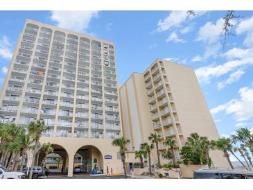 View of the exterior of the condo complex with multiple balconies and palm trees at 1205 S Ocean Blvd. # 20609, Myrtle Beach, SC 29577