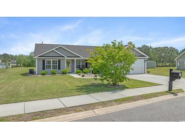 Charming single-story home with well-manicured lawn, rock garden, and attached two-car garage at 1536 Abberbury Dr., Conway, SC 29527