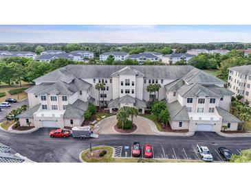 Stunning exterior view of a condo building with manicured landscaping and ample parking at 2180 Waterview Dr. # 1044, North Myrtle Beach, SC 29582