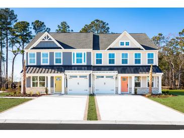 A view of new townhomes with colorful doors and attached garages at 2615 Elowen Ln. # 109A, Longs, SC 29568