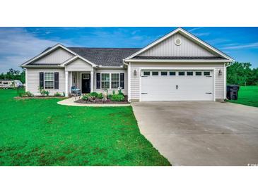 Charming one-story home features a two-car garage, landscaped front yard, and inviting entryway at 3148 Gause Rd., Loris, SC 29569