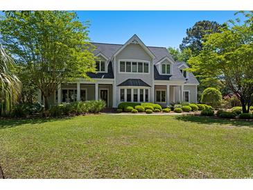 Beautiful two-story home with manicured lawn and mature landscaping at 352 Old Carriage Loop, Georgetown, SC 29440