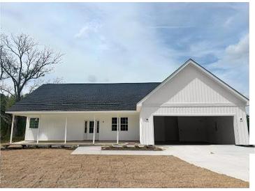 Charming single-story home featuring a covered porch, attached two-car garage and neutral color palette at 357 Log Cabin Rd., Loris, SC 29569
