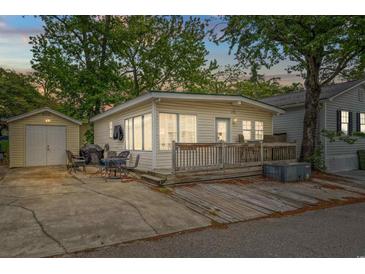 Charming beach home featuring a spacious wooden deck, convenient parking, and storage shed for all your beach necessities at 6001 - 1807 S Kings Hwy., Myrtle Beach, SC 29575