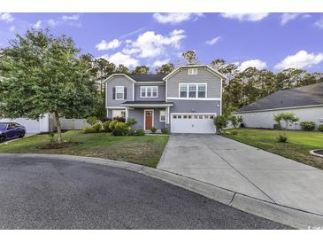 Charming two-story home with a well-manicured lawn and a driveway leading to a two-car garage at 6239 Chadderton Circle, Myrtle Beach, SC 29579