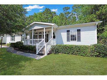 Charming single-story home featuring a welcoming front porch, well-maintained lawn, and mature landscaping at 6544 Amberwood Ct., Myrtle Beach, SC 29588