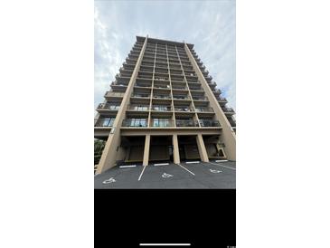 View of condo building showing parking and multiple floors of balconies at 7500 N Ocean Blvd. # 6120, Myrtle Beach, SC 29572