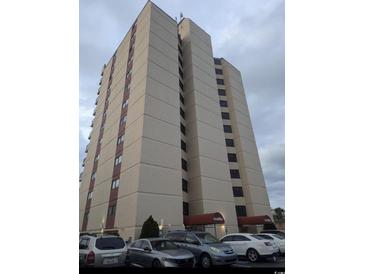 An exterior shot of a tall condo building with parking spaces at 7509 N Ocean Blvd. # 1205, Myrtle Beach, SC 29572