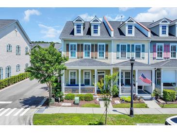 Charming townhome with a covered front porch and colorful shutters in a well-maintained community at 830 Shine Ave. # 28 R8, Myrtle Beach, SC 29577