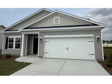 Charming single-story home featuring a two-car garage and a well-maintained front yard at 1029 Jase Dr., Longs, SC 29568