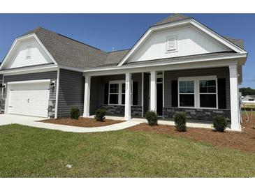 Charming single-story home with gray siding, stone accents, and a well-manicured front yard at 1037 Jase Dr., Longs, SC 29568