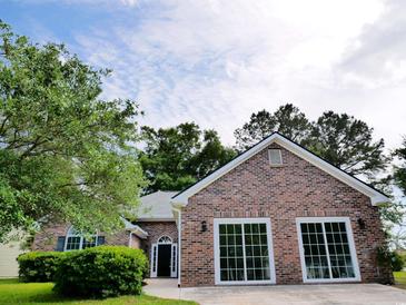 Charming brick home featuring a well-manicured lawn and a welcoming entrance with detailed trim work at 104 Jessica Lakes Dr., Conway, SC 29526