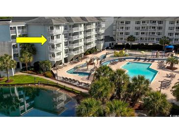 Beautiful pool area with multiple levels, seating, and lush landscaping at this condominium complex at 14290 Ocean Hwy. # 312, Pawleys Island, SC 29585