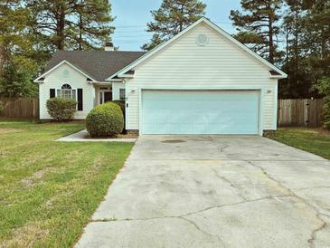 Charming single-story home with a two-car garage, well-kept lawn, and mature trees at 185 Lander Dr., Conway, SC 29526