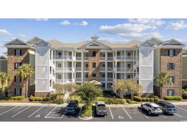Beautiful condo building with a well maintained exterior and balconies in a professionally landscaped community at 4828 Magnolia Lakes Dr. # 404, Myrtle Beach, SC 29577