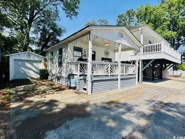 Charming coastal home with a welcoming front porch and a lush, green yard at 6001 - 1864 S Kings Hwy., Myrtle Beach, SC 29575