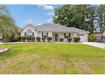 Charming one-story home with well-manicured lawn and decorative shrubs at 605 Cavandish Dr., Myrtle Beach, SC 29588