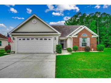 Charming single-story home featuring a two-car garage, manicured lawn, and lovely brick accents at 113 Camrose Way, Myrtle Beach, SC 29588
