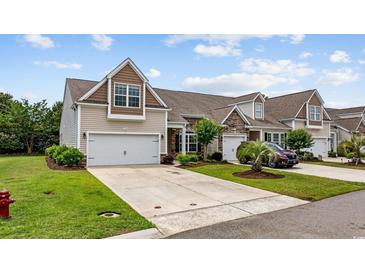 Charming townhome with a two-car garage, well-manicured lawn, and beautiful landscaping at 122 Parmelee Dr. # A, Murrells Inlet, SC 29576