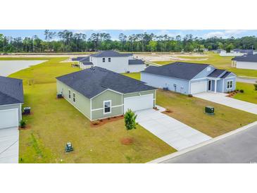 A new construction home with an attached garage and a well-manicured lawn in a suburban neighborhood at 1372 Palm Springs Paloma Dr, Longs, SC 29568