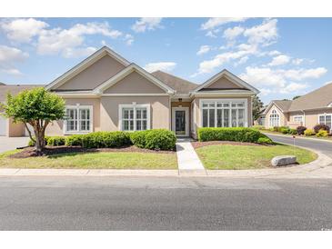 Charming one-story home featuring well-manicured landscaping and traditional architectural details at 1435 Saint Thomas Circle # E-1, Myrtle Beach, SC 29577