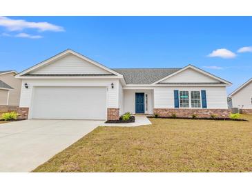 Charming single-story home with a two-car garage, brick accents, and a well-manicured lawn at 154 Six Mile Creek Dr., Georgetown, SC 29440