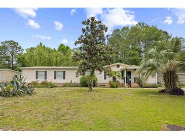 Charming single-story home with a well-manicured lawn and mature trees, creating a welcoming curb appeal at 1894 Athens Dr., Conway, SC 29526