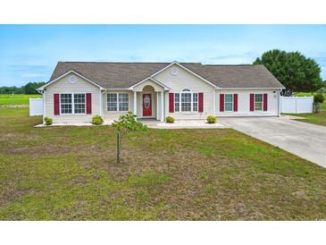 Charming single-story home with red shutters and a well-maintained lawn at 212 Sweetbay Magnolia St., Loris, SC 29569