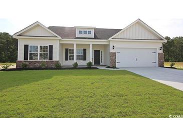 Charming one-story home with manicured lawn, brick accents and attached two-car garage at 268 Stillbrook Dr., Longs, SC 29568