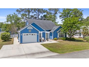 Charming blue single-Gathering home featuring a garage and inviting pergola-covered patio, surrounded by lush landscaping at 284 Nature Trail, Little River, SC 29566