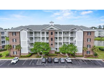 Stunning condominium building with ample parking and beautiful landscaping at 4887 Luster Leaf Circle # 105, Myrtle Beach, SC 29577