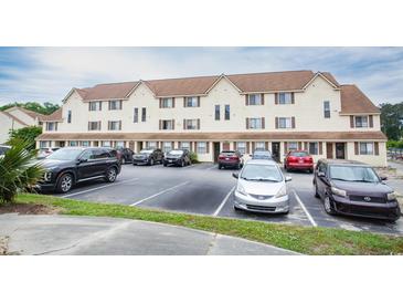 Exterior of the condo building with ample parking spaces available for residents and visitors at 510 Fairwood Lakes Dr. # 17-P, Myrtle Beach, SC 29588